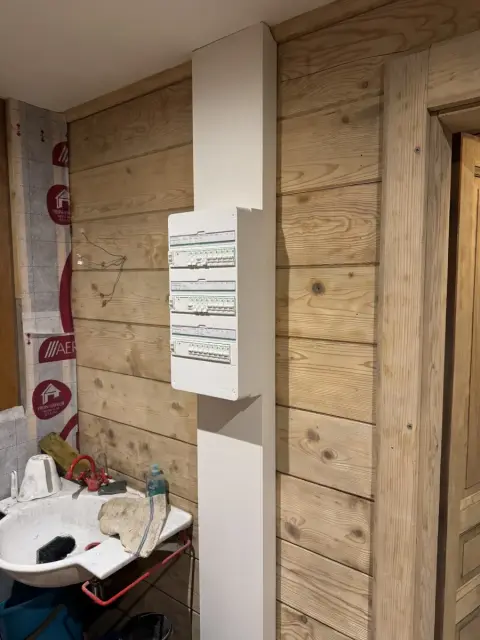 Tableau électrique posé sur un mur en bois